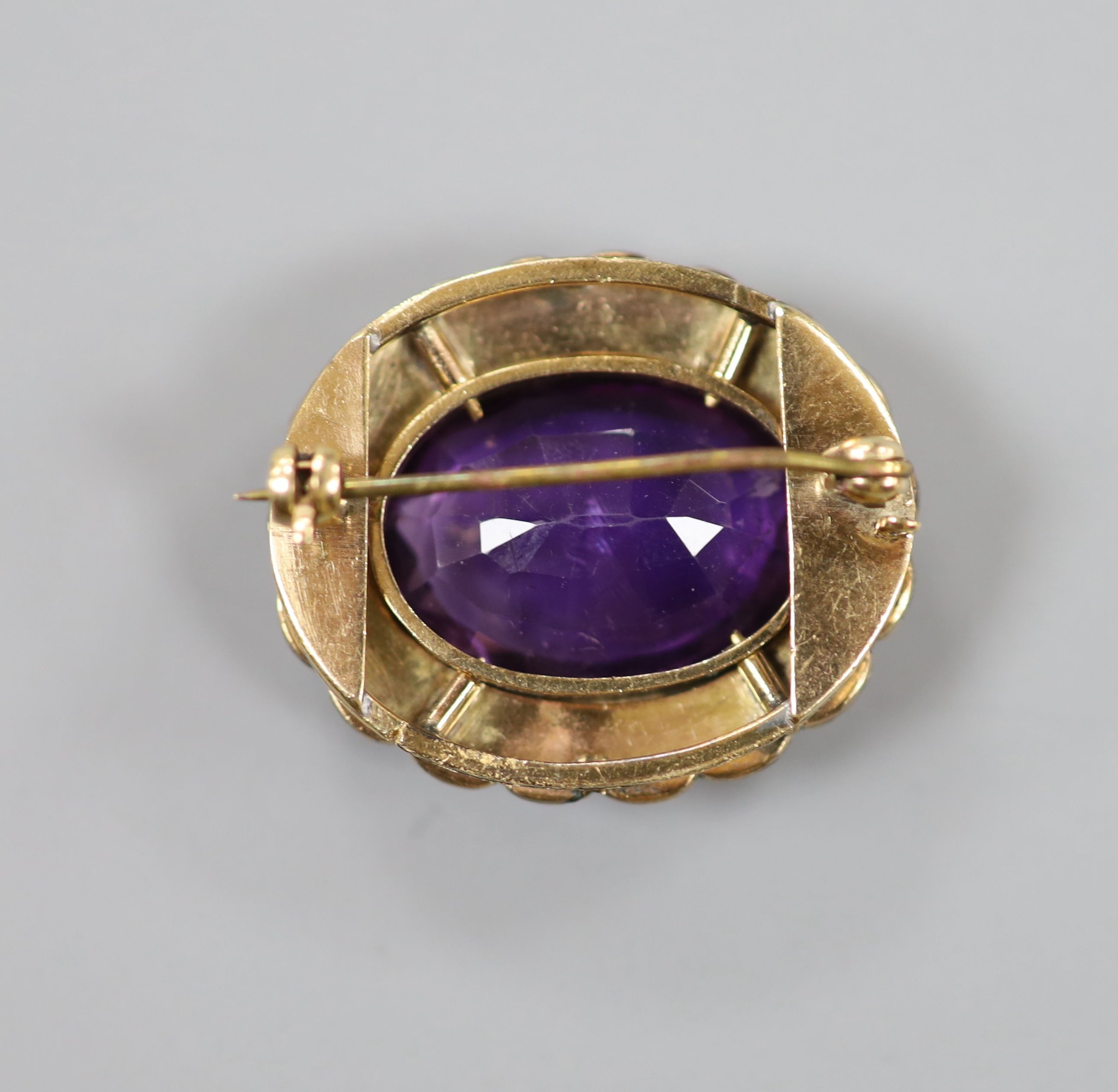A late Victorian yellow metal, amethyst and split pearl set oval brooch, 28mm, gross weight 10.3 grams.